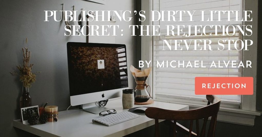 Picture shows a tidy desk with a computer and a cup of coffee in front of a window with the post title "Publishing's Dirty Little Secret--the Rejections Never Stop" and post author Michael Alvear's name superimposed.