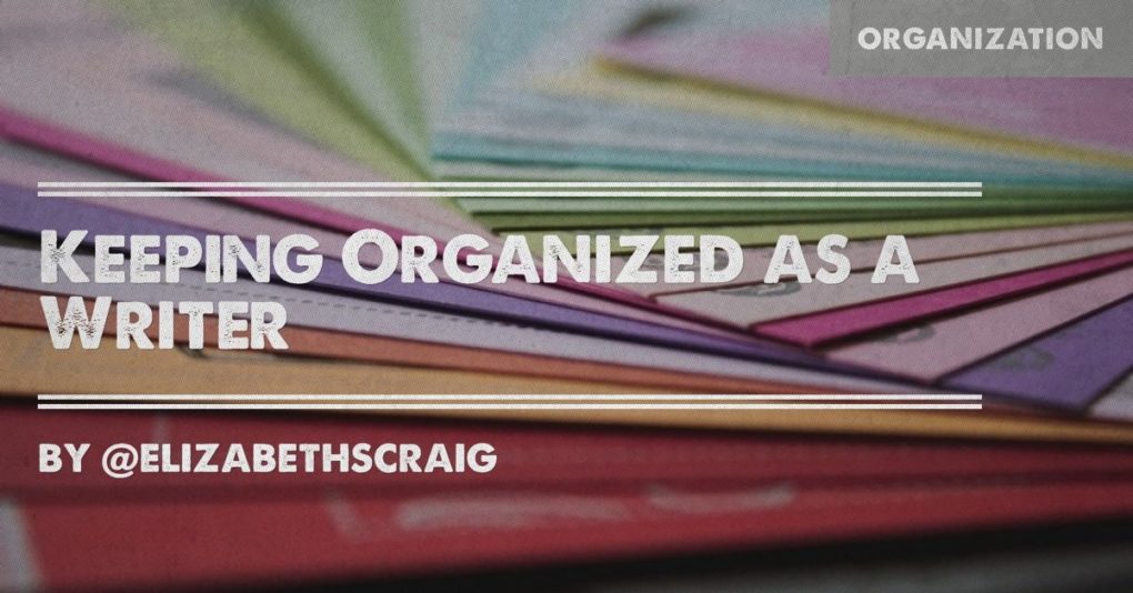Colorful paper and folders are in the background and the post title, 'Keeping Organized as a Writer' is superimposed on the top.